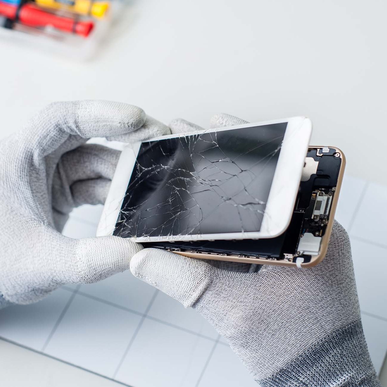 Close-up photos showing process of mobile phone repair, changing the screen.